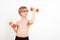Kid exercising with dumbbells in health sporty club. Healthy childhood, lifestyle