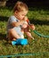 Kid exploring water hose