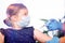 Kid in face mask, coronavirus protect. Vaccine cure