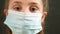 kid face in medical mask. covid coronavirus pandemic medicine concept. portrait of a face girl kid child covid in a