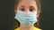 kid face in medical mask. covid coronavirus pandemic medicine concept. portrait of a face girl kid child in a protective