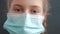 kid face in medical mask. pandemic coronavirus medicine concept. portrait covid of a face girl kid child in a protective