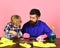 Kid with father cleaning together with spray.