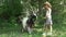 Kid Feeding Goat in Courtyard, Farmer Cowboy Child Pasturing Animals in Field, Girl with Animals in Garden