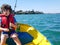 Kid fishing from small dinghy on Tauranga Harbour.