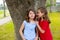 Kid friend girls whispering ear playing in a park tree