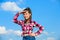 Kid girl checkered fashionable shirt posing sunny day blue sky background. Child cute girl long hair ponytail hair