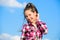 Kid girl checkered fashionable shirt posing sunny day blue sky background. Fashion model girl. Stylish fashionable kid