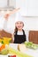 Kid girl chef on countertop funny gesture with roller knead