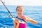 Kid girl fishing tuna little tunny happy with fish catch