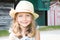 kid girl five year old posing outdoors Looking camera Childhood Closeup portrait of blonde child with straw hat