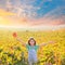 Kid girl in happy autumn vineyard field open arms with red leaf