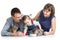 Kid girl and her parents feeding cats kittens