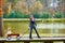 Kid girl and mother walking in lake with pull cart