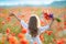 Kid girl move thru blooming field with red wild flowers