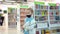 Kid girl in protective medical mask chooses book on shelf in store or library.
