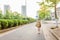 Kid girl pupil from behind walking back to home after learning study school alone with schoolbag, preschool and kindergarten