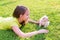 Kid girl and puppy dog happy lying in lawn