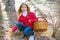 Kid girl searching chanterelles mushrooms with basket in autumn