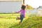 Kid girl toddler playing running in park rear view