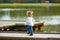 Kid girl walking in the lake pier