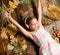 Kid girl wooden background listen music headphones. Autumn melody concept. Child listen music relaxing top view. Autumn