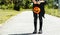 Kid going trick or treating. Low section shot of child in festive Halloween costume with cute jack-o-lantern. Child girl in witch