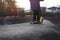 kid with golden stunt scooter stands on elevation in modern asphalted pump track park