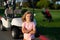 Kid in golf park near golf cart. Child summer vacation. Lifestyle portrait of funny kid outdoors. Summer kids outdoor