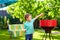 Kid grilling food on backyard party