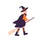 Kid in Halloween party costume of witch. Disguised girl in hat, cloak cape, orange and black stockings. Child with broom