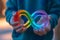 Kid hand holding autism infinity rainbow symbol sign. World autism awareness day, autism rights movement, neurodiversity