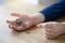 Kid hand holding pound coins on wooden table, Kid learning  counting and how different about money coins, Children learning  about