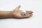 Kid hand showing money coins , child holding a coins on his hand isolate on white background