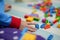 Kid hand touch colorful bricks toy on mat floor for playing