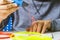 Kid hands with 3d printing pen, colorful filaments on white desk.