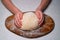 Kid hands knead yeast dough for pizza or pie