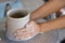 A kid hands making a vase pottery after got teaching from the old hand