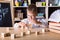 Kid hands playing building pyramid of cubes, child studying construction in classroom
