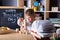 Kid hands playing building pyramid of cubes, child studying construction in classroom