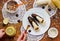 Kid hands preparing creative breakfast from banana in chocolate