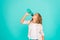 Kid hold bottle blue background. Water balance concept. Healthy and hydrated. Pediatric disorders of water balance. Girl