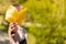 Kid holding autumns yellow leaves in hand. Close his face. Copy space