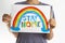 Kid holding drawing picture with rainbow with words Stay at home. Social media campaign for coronavirus prevention