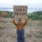 Kid holding a poster with anti-racism message, activism and human rights movement