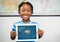 Kid holding tablet grey brain and white space doodles against dark blue background