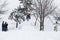 Kid jumping over a hill made of snow with snowboard 