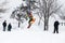 Kid jumping over a hill made of snow with snowboard 