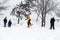 Kid jumping over a hill made of snow with snowboard 