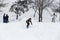 Kid jumping over a hill made of snow with snowboard 